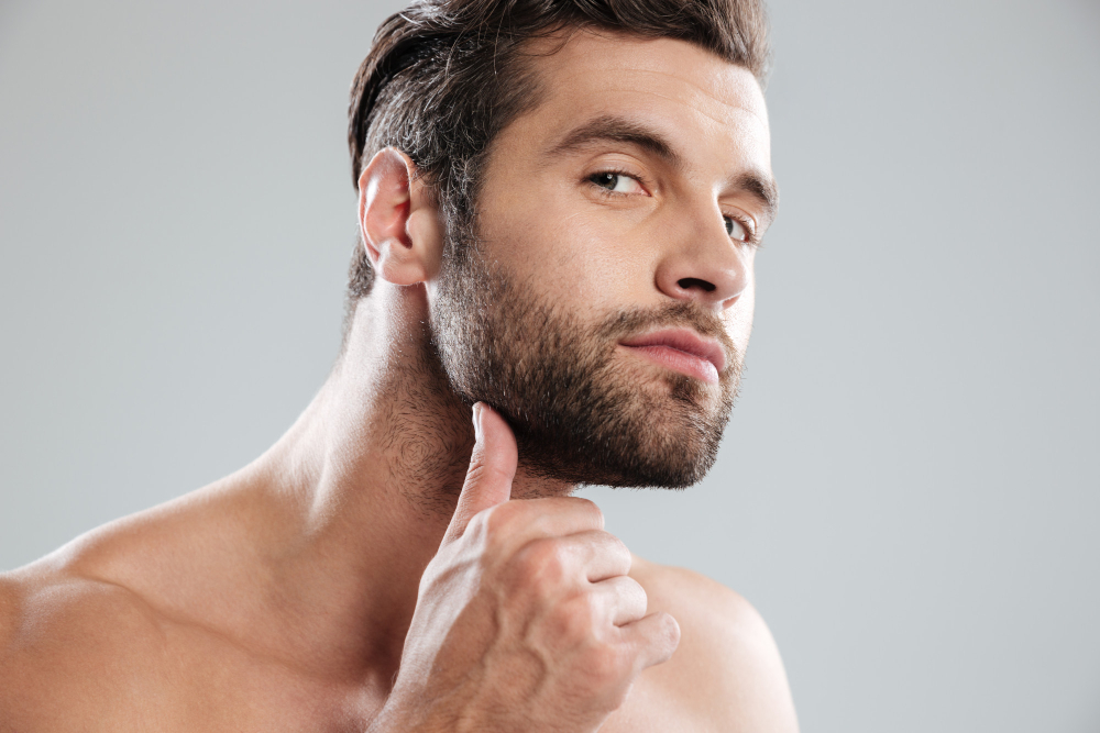 portrait-handsome-naked-bearded-man-examining-his-face