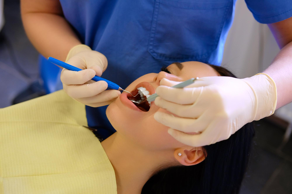 dentist-hands-working-young-woman-patient-with-dental-tools